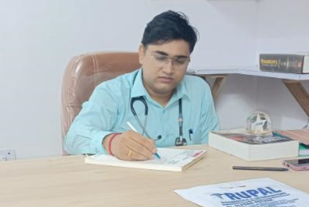 Professional portrait of Dr Rupesh in white medical coat with professional background